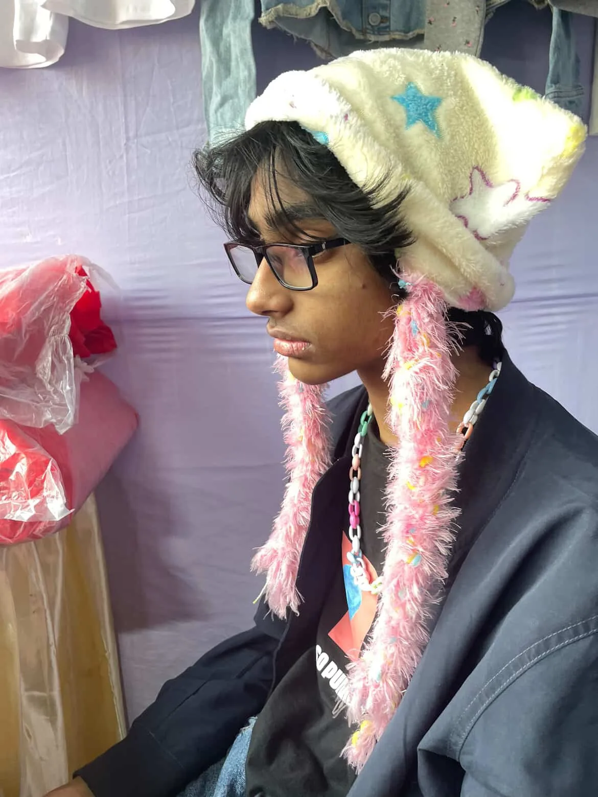 Zuhayer in a fuzzy star-print hat, looking to the side